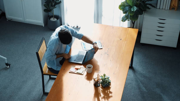 istock Top view of business man working on laptop while looking at chart. Convocation. 2084954580