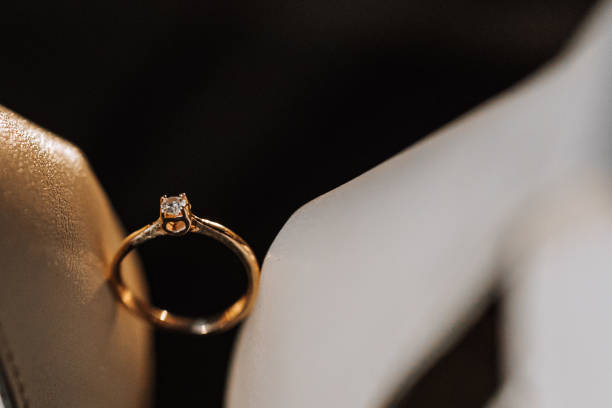 istock gold women's ring on a dark background, a man makes a marriage proposal to his girlfriend 2084968247