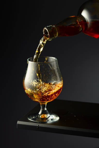 istock Cognac or brandy being poured into a glass. 2084969904