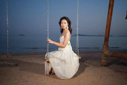 young woman sitting on swing