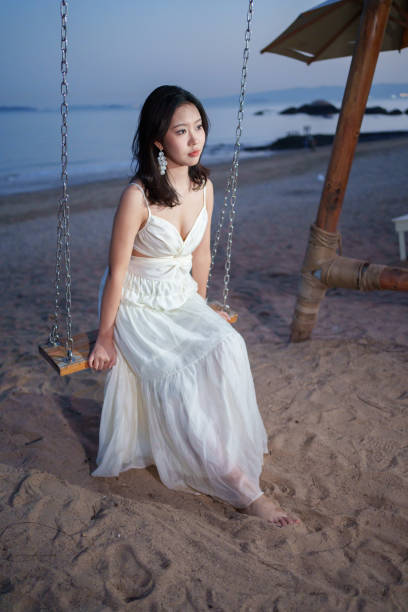 istock Asian girl sitting on the swing 2084971377