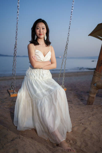 istock Beautiful girl sitting on the swing 2084971576