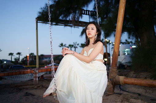 Beautiful woman sitting on swing