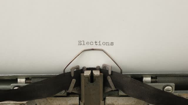 typing motivational announcement Elections on a vintage typewriter close-up