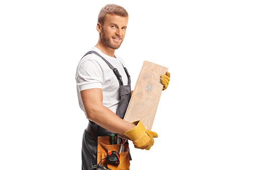 Worker holding a wooden beam isolated on white background
