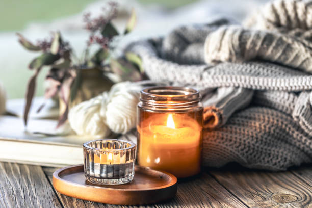 istock Home composition with burning candles, knitted elements and books. 2084984138