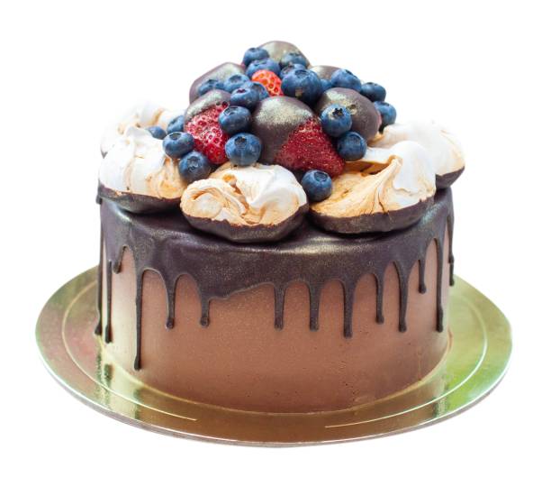istock Chocolate cake decorated with strawberry dipped into melted chocolate, raspberry, blueberry and meringue. Isolated on plain background 2084984151