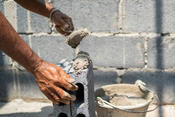 istock man is building a wall with a bucket of cement 2084986283