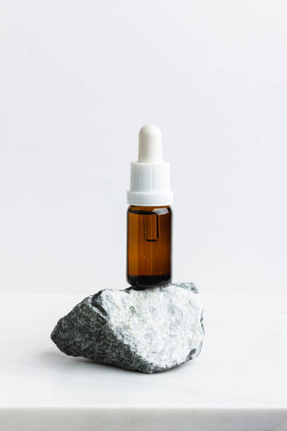 istock Serum in the brown bottle for face on white marble. 2084986288
