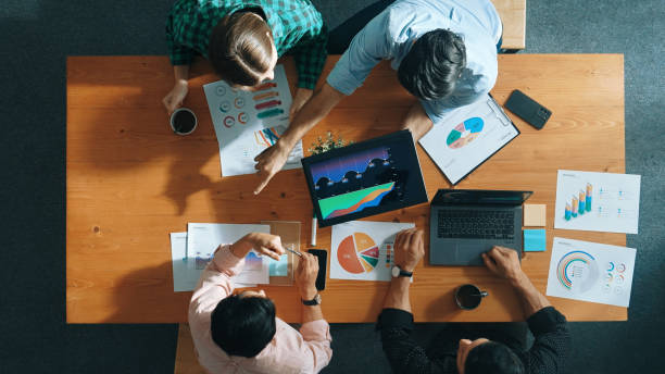istock Top view of business people hand working together to analyze chart. Convocation. 2084995873