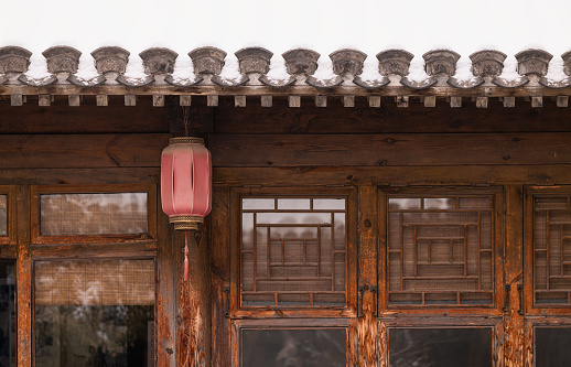 Red lantern hanging on roof of Chinese traditional building. Beijing, China