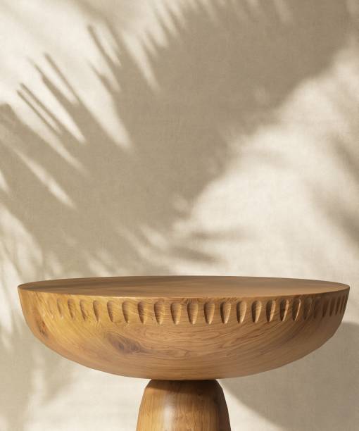 istock Round wooden pedestal table podium in sunlight, palm leaf shadow on beige brown wall 2085008021