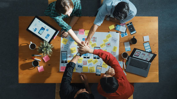 istock Skilled team putting hand together to celebrate at meeting table. Convocation. 2085014761