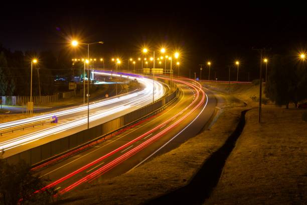 istock curved road with vehicle lights, long exposure 2085018303