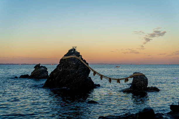 Meoto Iwa (the Wedded Rocks) are two sacred rocks in the ocean near Futami, a small town in Ise City, Mie-ken, JAPAN- 11, 24, 2020The larger of the two rocks represents the husband and the smaller one represents the wife.
