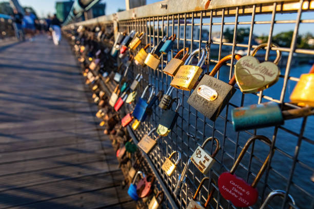 Krakow, Poland - 09-06-2023: Father Bernateks Bridge covered with many locks at sunny day in Krakov Poland
