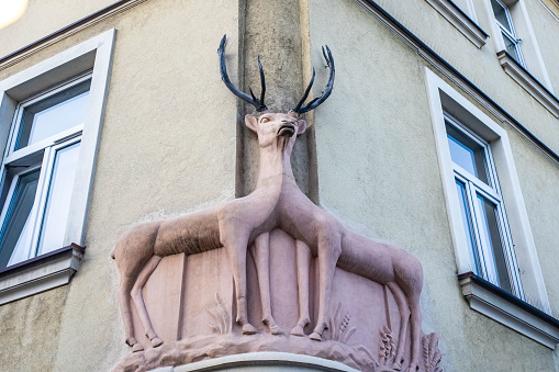Krakow, Poland - 09-06-2023: House deer sculpture exterior decoration