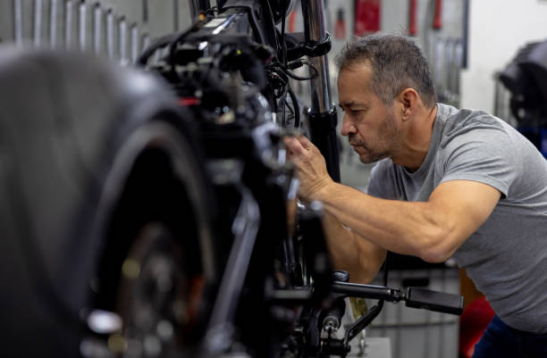 istock Mechanic repairing a motorcycle at a garage 2085107538