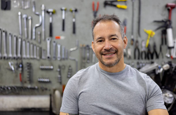 istock Mechanic smiling at a motorcycle repair shop 2085107780