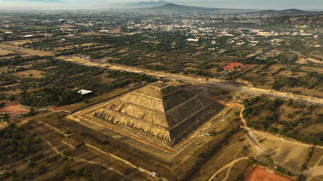 Pyramid of the sun, sunlit by the morning sunlight, in Teotihuacan, Mexico - Aerial view
