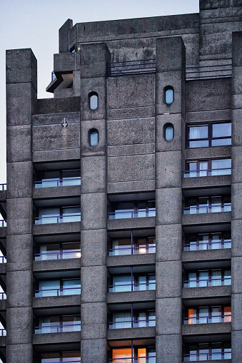 The Barbican Estate, The Barbican Centre, The City Of London, United Kingdom - 2024: A significant architectural and cultural landmark in London. The Barbican Estate in London. A cohesive urban environment and high-density living in the heart of London, within the Barbican area of the City of London. A large residential and cultural complex located in the City of London. A prominent example of Brutalist architecture.
The Barbican Estate residential blocks: concrete construction in the heart of London's financial district, showcasing Brutalist architecture at its finest.