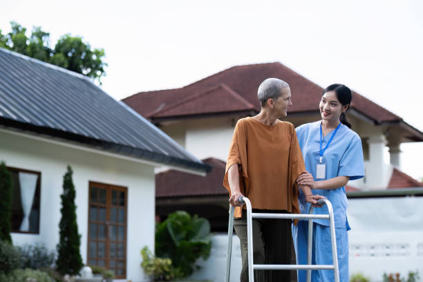 istock Nurse or caregiver hand on walking frame for support, help or trust moving leg in rehabilitation. Physiotherapy healthcare, Medical caregiver consulting disabled elderly patient at home 2085130996