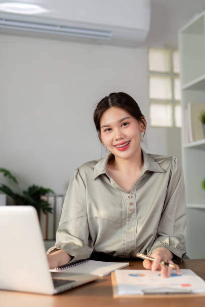 istock Businesswoman using laptop computer and calculator working at home with calculator document on desk, finance analysis concept 2085138191