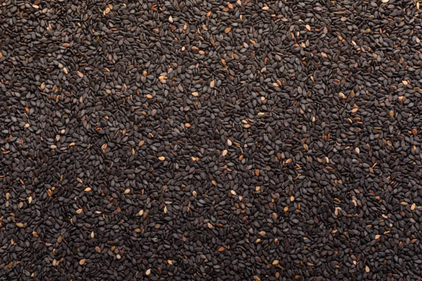 Black sesame seeds, an ingredient for making vegetarian and healthy food. Close-up image of food background texture stock photo