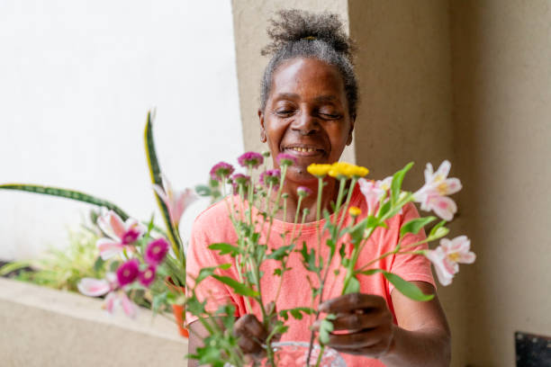 istock Black senior women smiling with flowers 2085156477