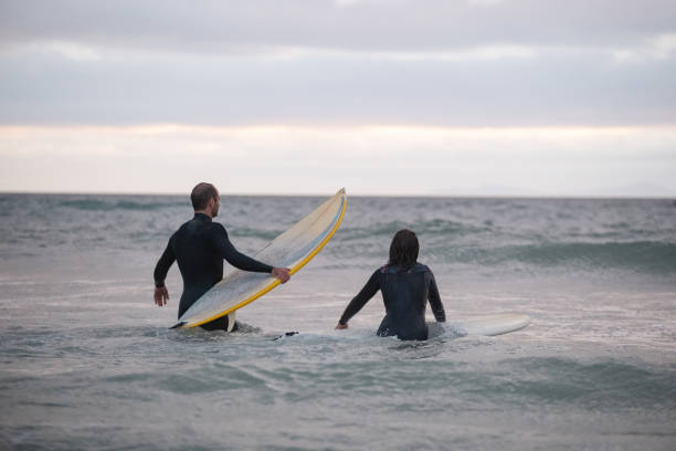 istock Couple enjoying a late afternoon surf 2085179998