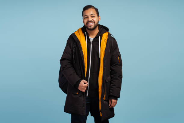 istock Happy african-american man with braces looking at camera, wearing winter jacket 2085204794