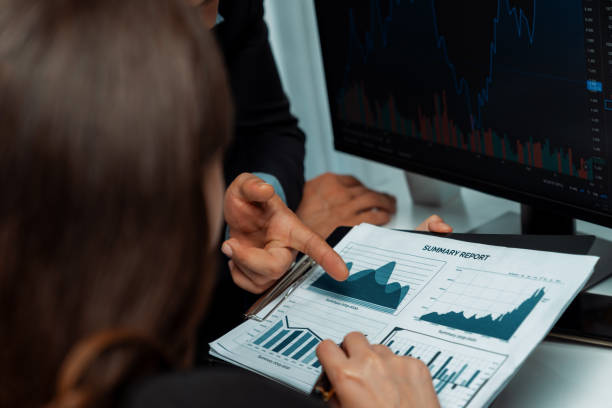 istock Two business traders discussing business statistic on report paper. Postulate. 2085222923