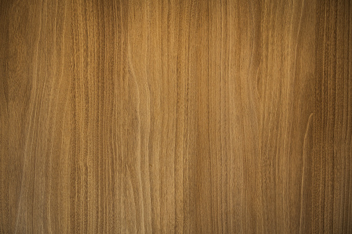 A wooden surface with a grainy texture. The wood appears to be aged and has a rustic feel. Wood Background Concept.