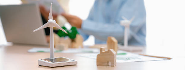 istock Windmill model and wooden block was scatter around on the table. Delineation. 2085276998