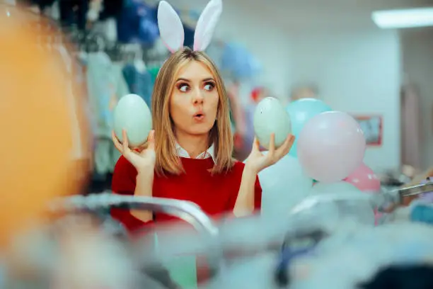 Photo of Funny Shopping Assistant Celebrating Holding Easter Eggs