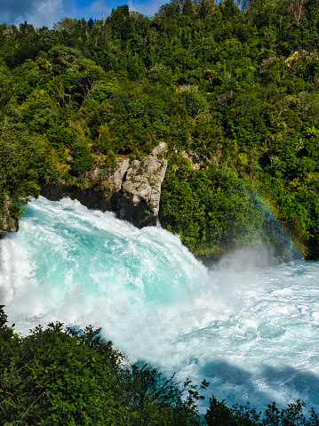 Stunning aerial wide angle view of Huka Falls waterfall in Wairakei near Lake Taupo in New Zealand. The waterfall is part of the Waikato River