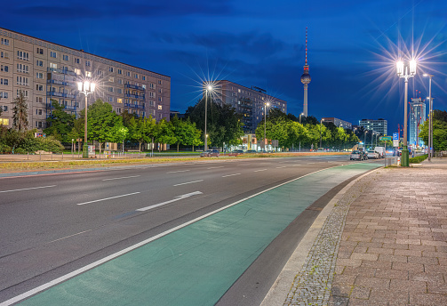 The famous Television Tower of Berlin with a big incoming road at night