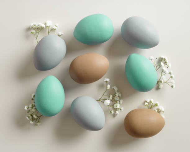 istock Easter Eggs pattern with White Gypsophila flowers on Light beige Background. Dyed colorful eggs in pastel colors, spring holiday photo, tender soft hues, flatly of celebration food and white blooms 2085327681