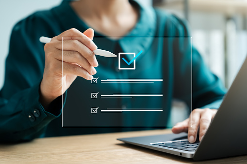 Business performance monitoring concept, businesswoman using laptop Online survey filling out, digital form checklist.