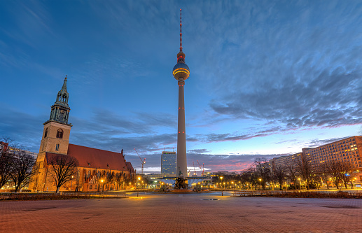 The Alexanderplatz in Berlin with the famous Television Tower and the Marienkirche before sunrise