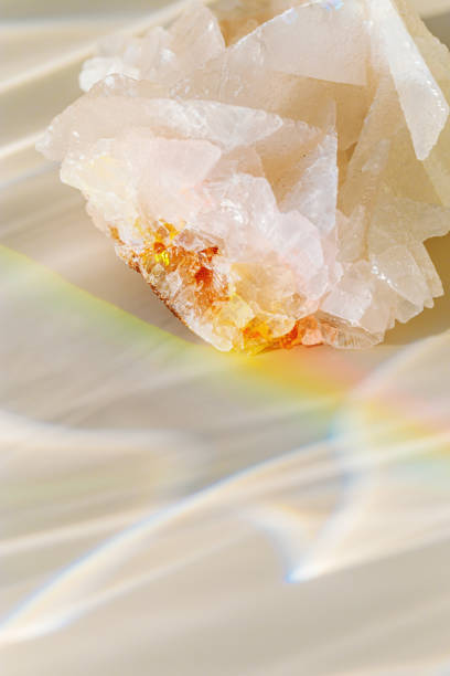 istock Luminous Quartz with Rainbow Flares. Sun's rays interact with quartz stone, iridescent rainbow glares, background with shining crystal at sunlight, aesthetic view with natural light effect 2085336814