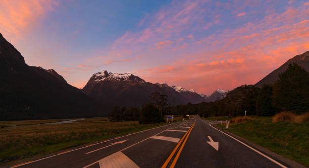 the road trip view of  travel with mountain view of autumn scene and  foggy in the morning with sunrise sky scene at fiordland national park - sunrise new zealand mountain range mountain - fotografias e filmes do acervo