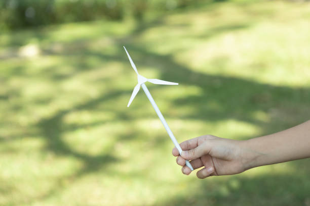 istock Little boy holding windmill or wind turbine mockup model. Gyre 2085407264