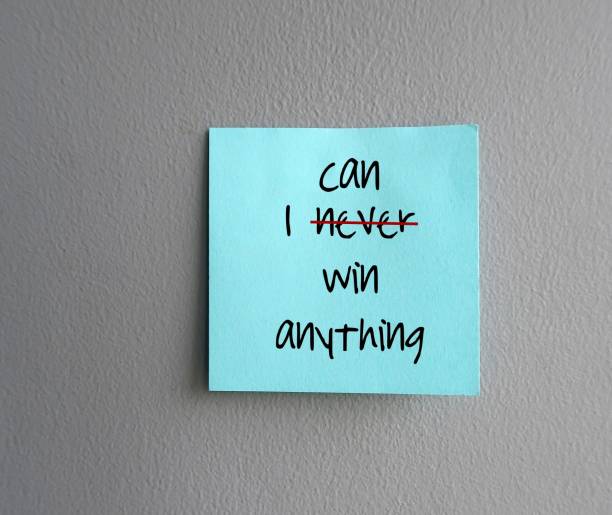 istock Blue note written I NEVER WIN ANYTHING (cross off NEVER replace with CAN) concept of change negative self talk to positive one, overcoming inner voice critic 2085439128