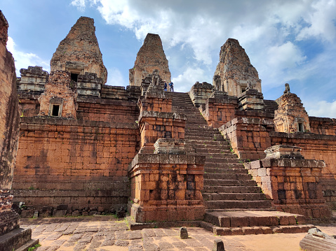 Tourists sightseeing on top of Pre Rup, a Hindu temple at Angkor, Cambodia, built as the state temple of Khmer king Rajendravarman.