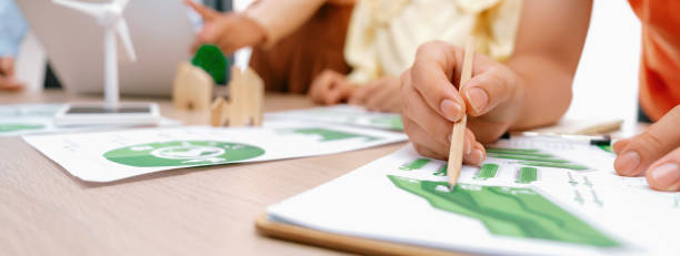 istock Windmill model placed during presenting green business. Closeup. Delineation. 2085476920