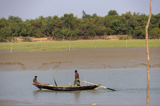 Noakhali, Bangladesh - 4 March 2024 - Local fishermen with their fishing boats. It is the Choto Feni River of Noakhali district in Bangladesh.