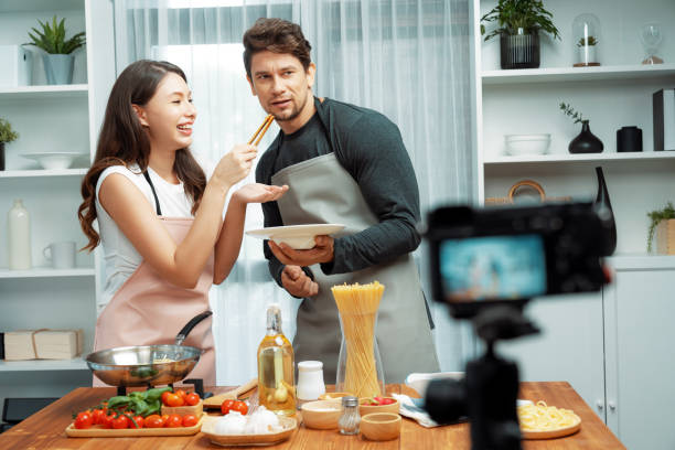 istock Chef influencers cooking special spaghetti with tongs to fried pan. Postulate. 2085507178