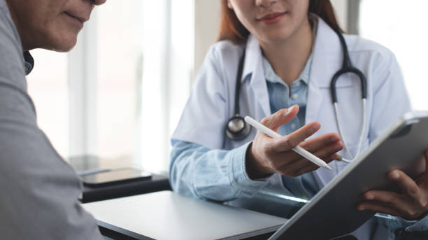 istock Female asian smiling doctor showing digital tablet screen to patient, explaining checkup result, medical screening, giving consultation on appointment at medical clinic, close up 2085513941