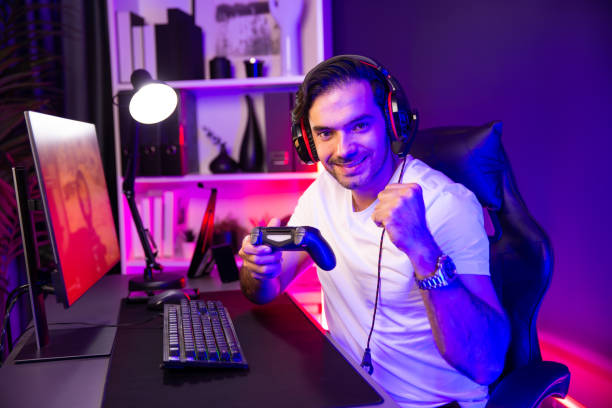 istock Smart gaming streamer with joystick looking camera with shooting game. Surmise. 2085523210